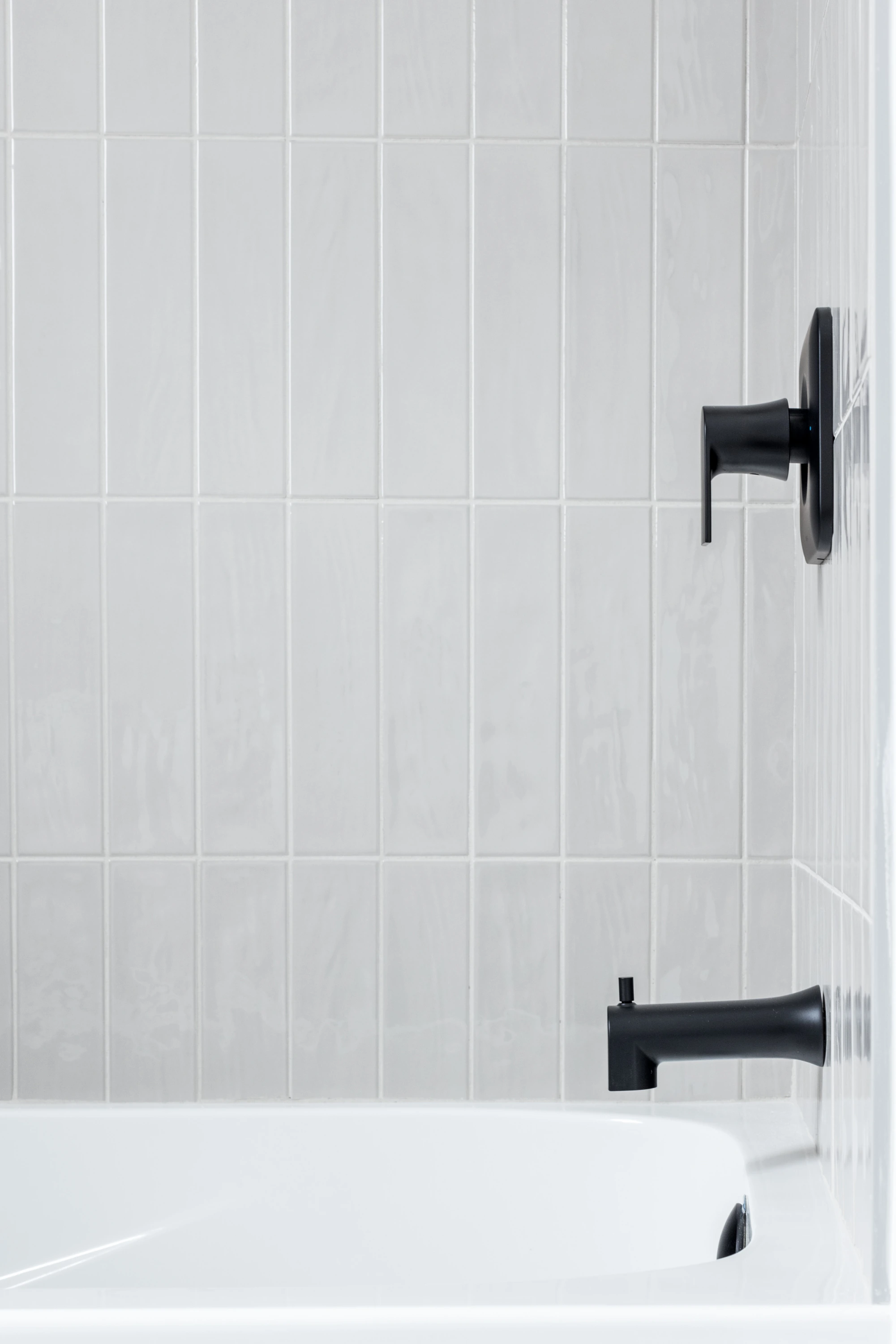 The East Coast — Tub surround and black shower fittings